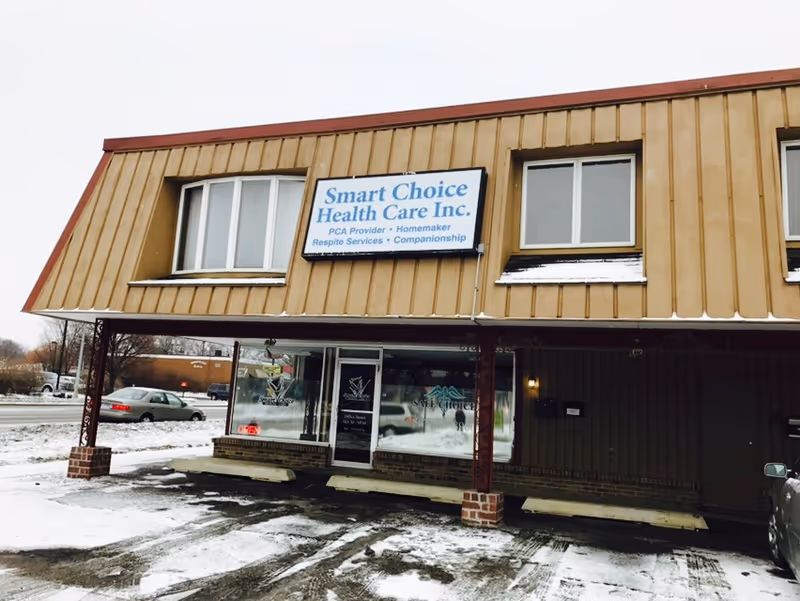 Exterior view of Smart Choice Health Care Inc storefront with sign, windows, and snow.
