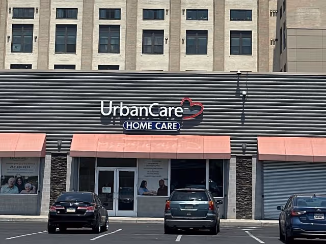 Front view of UrbanCare Home Care storefront with cars parked in front.