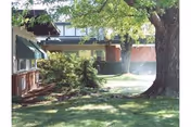 Outdoor view of Crescent Health Care facility with trees, lawn, and entrance.