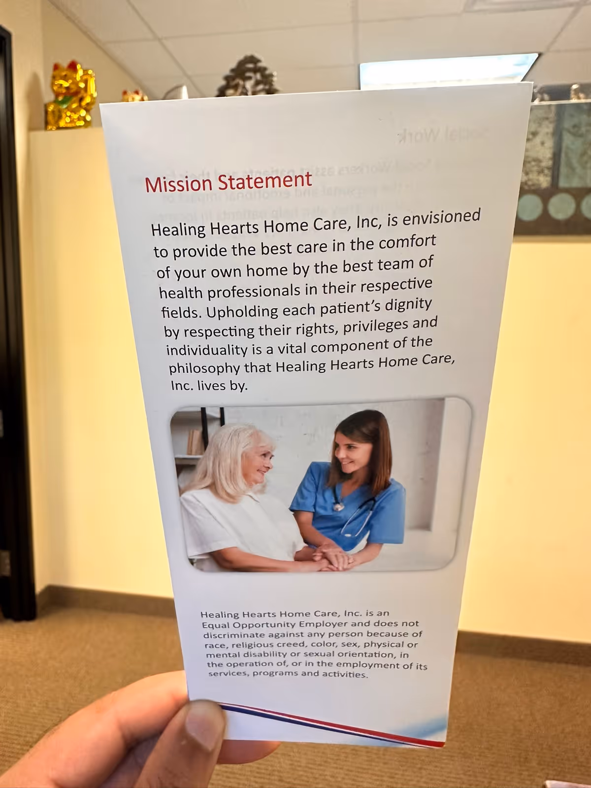 Hand holds brochure displaying Healing Hearts Home Care INC Mission Statement; nurse and elderly patient pictured.