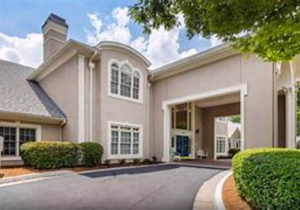 Front exterior of Regency House of Buford with entrance and landscaping.