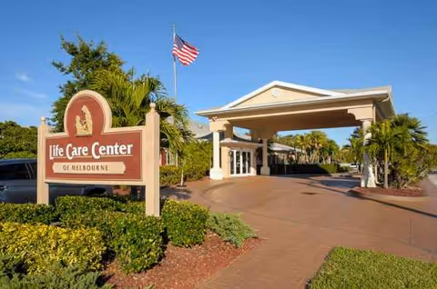 Entrance of Life Care Center of Melbourne with a porte-cochère and flag