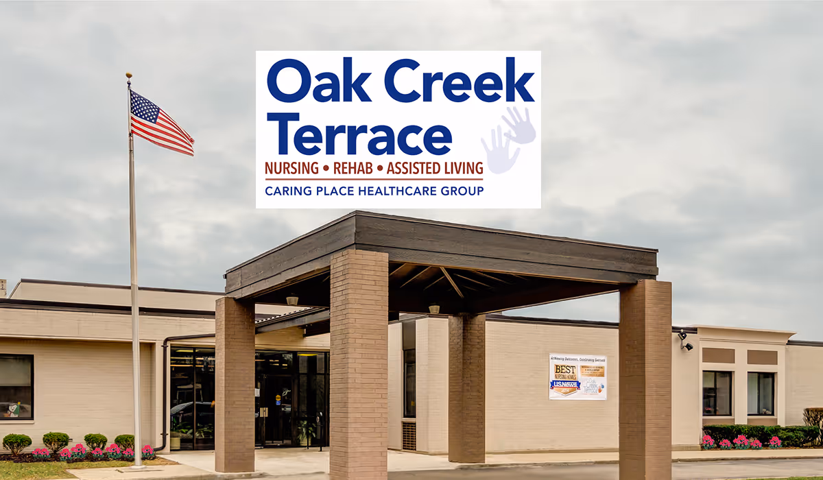 Exterior view of Oak Creek Terrace Nursing & Rehab Center entrance with flagpole.
