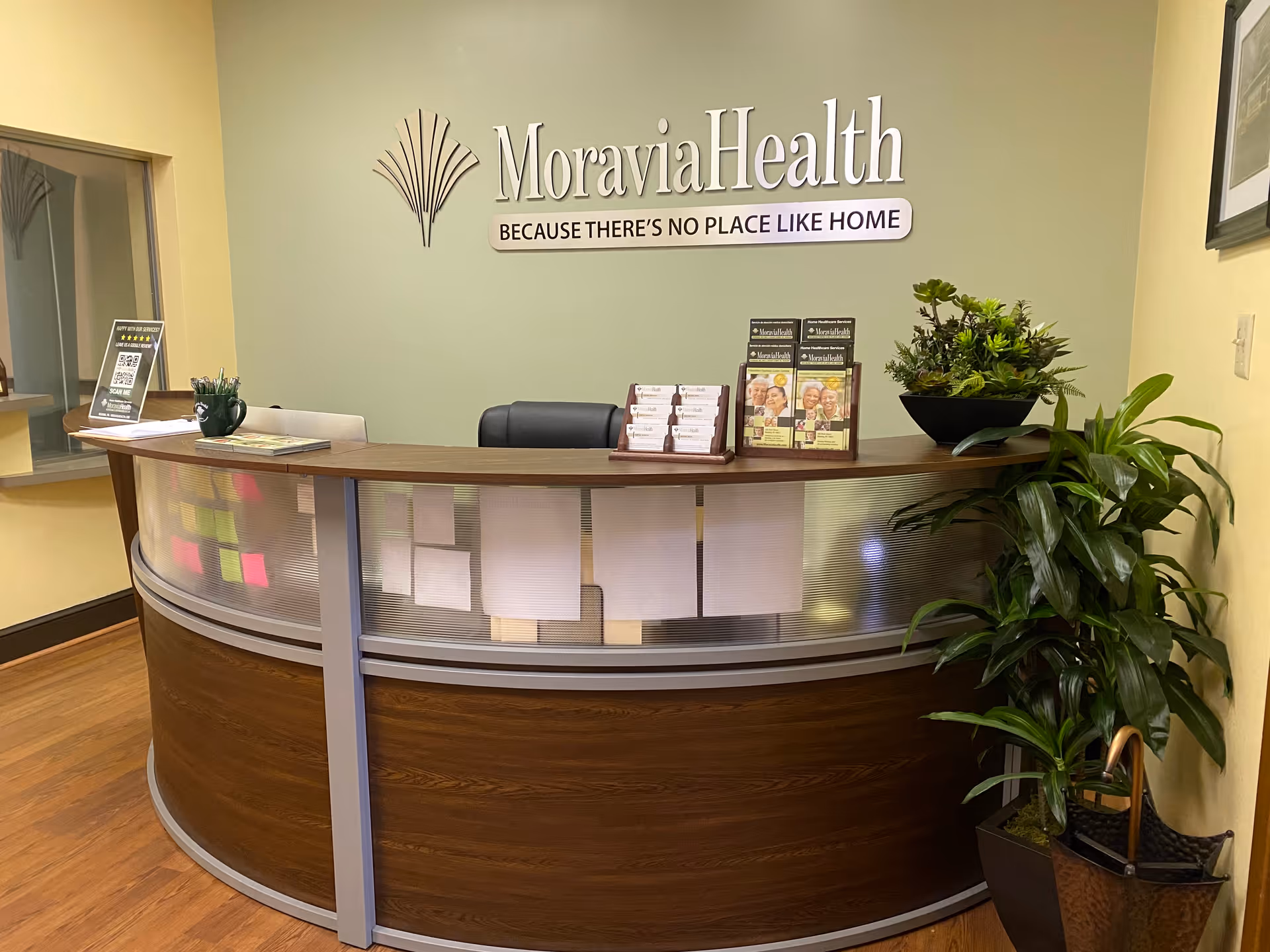 Reception desk in MoraviaHealth Reading lobby with plants and brochures.