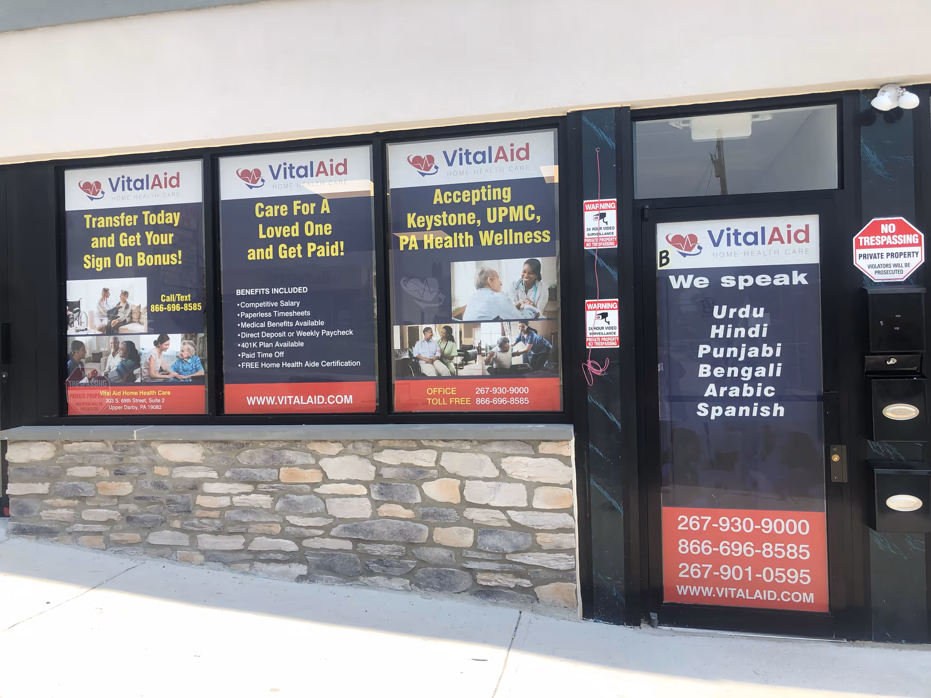 VitalAid Home Health Care storefront with window posters and a door.