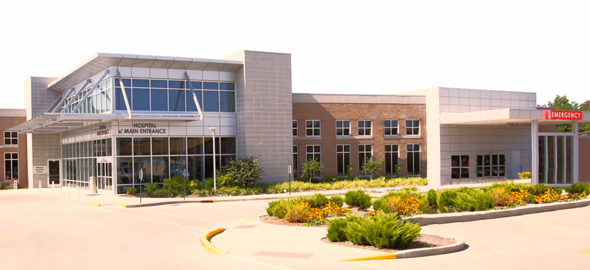 Exterior view of Hillsboro Health facility with main entrance and surrounding landscaping.