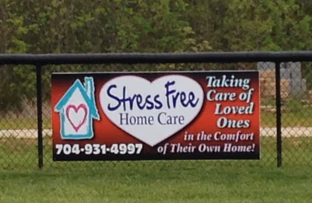 Outdoor fence sign advertising Stress Free Home Care with phone number.