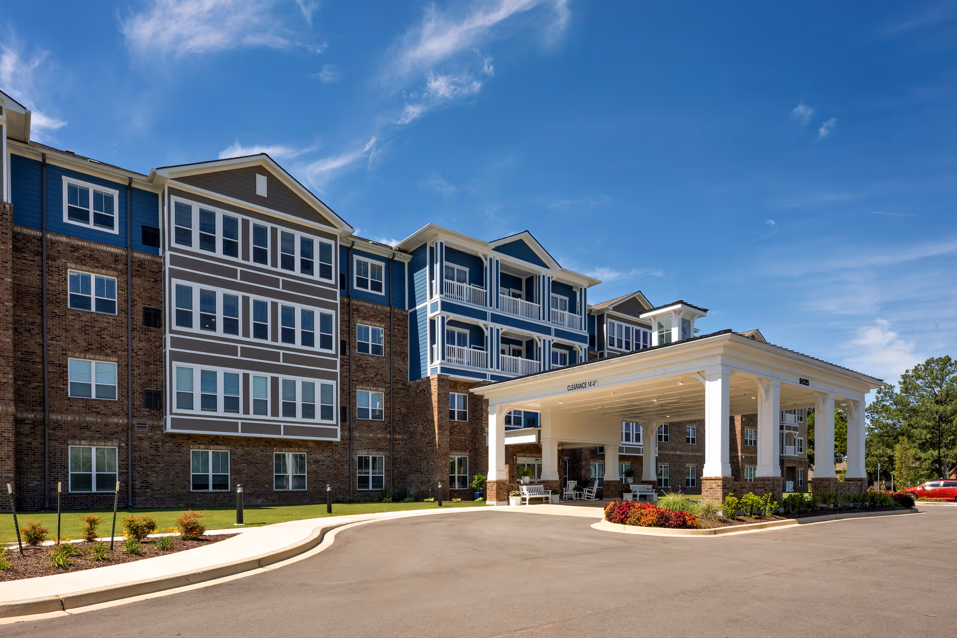 Harmony at Morning Grove exterior: blue siding, brick accents, and a covered entrance.