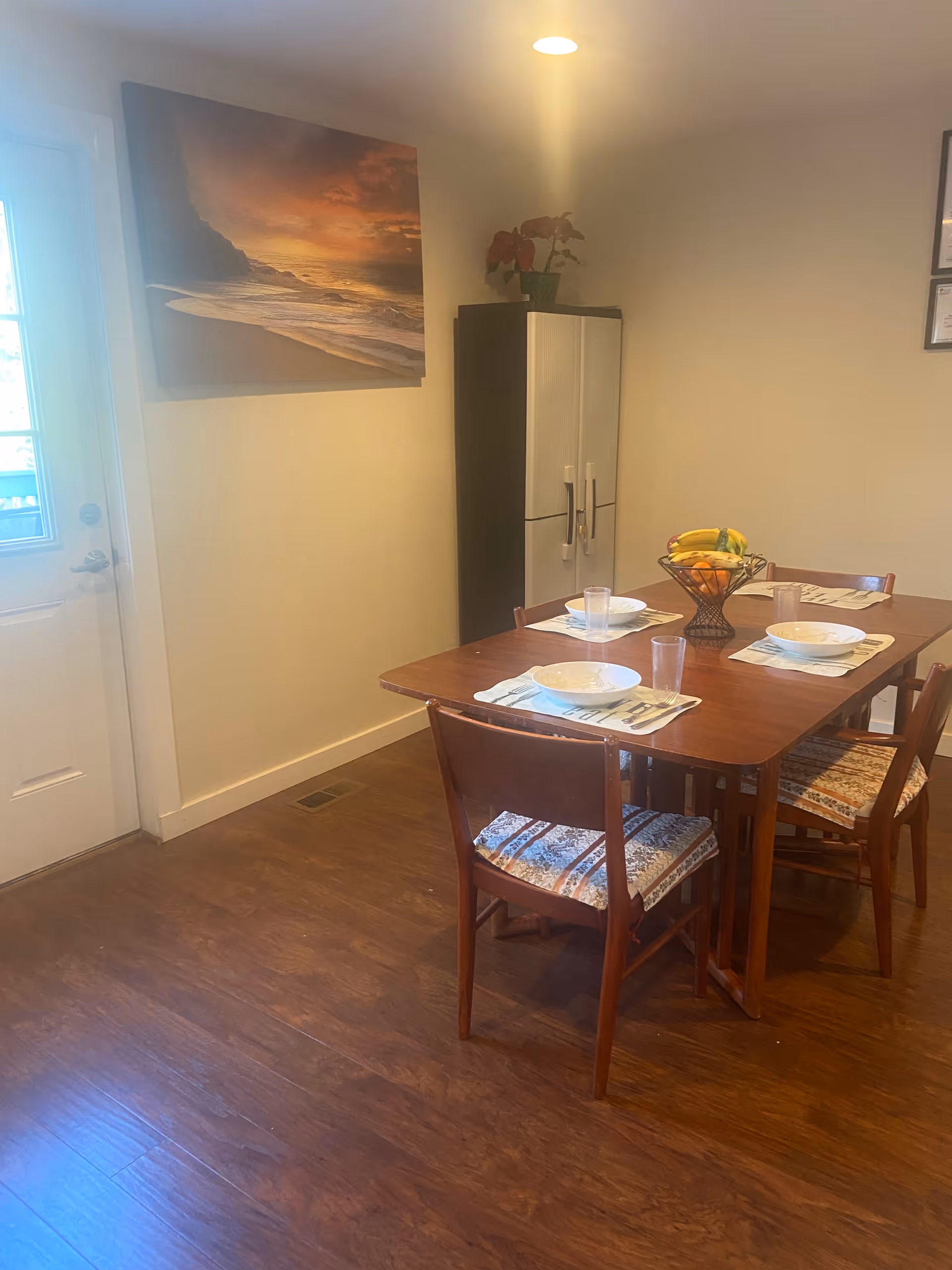 Dining area in a senior home with a four-seat table and place settings.