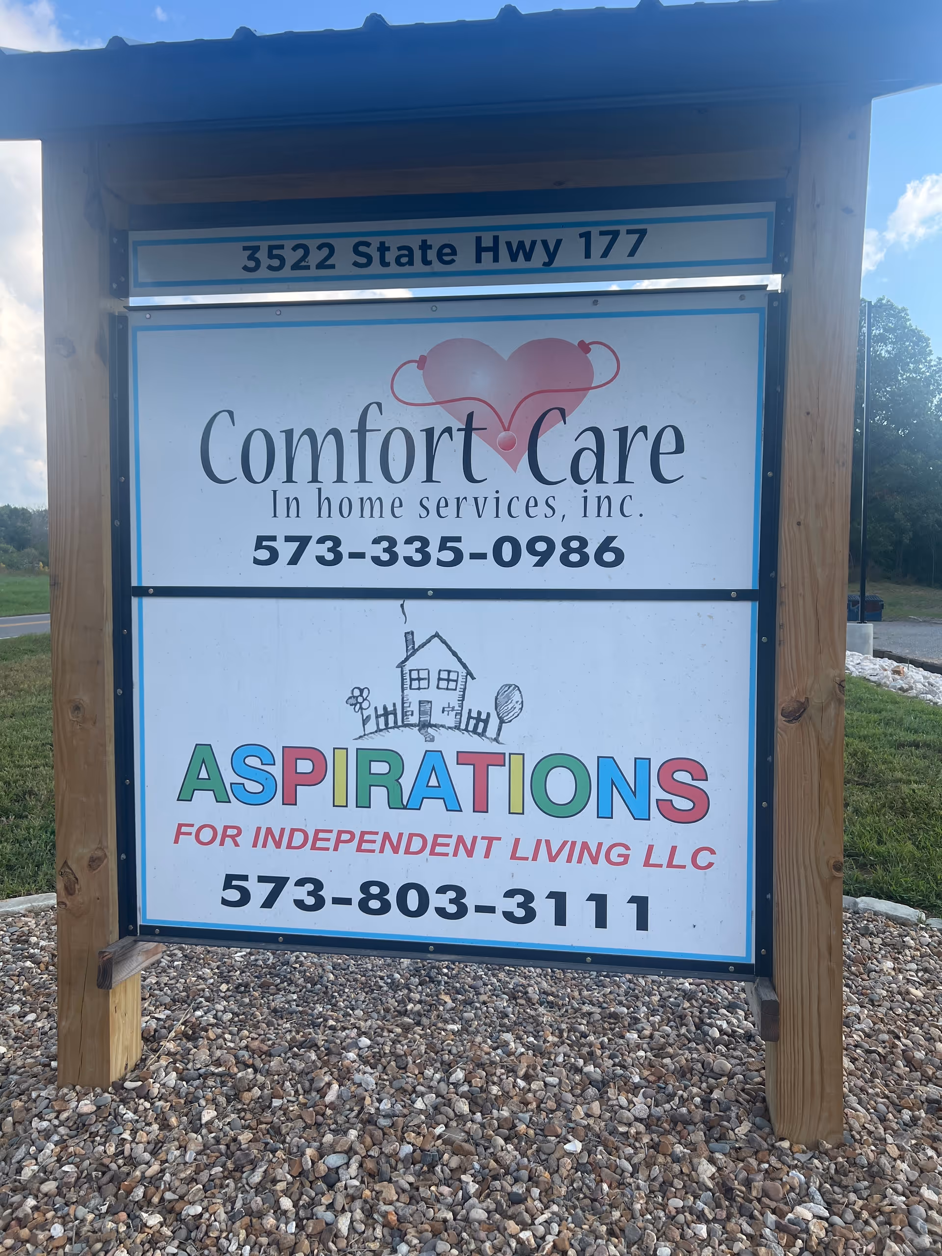 Outdoor wooden frame sign advertising Comfort Care In Home Services and Aspirations for Independent Living LLC.
