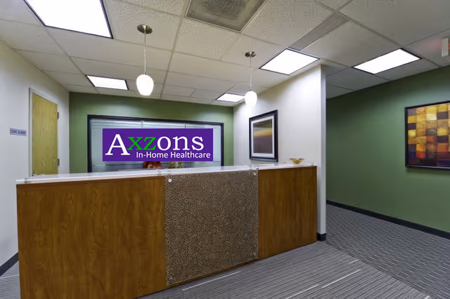 Lobby reception desk with Axzons signage in a healthcare facility.