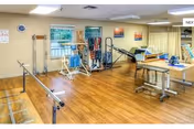 Southwood Care Center interior rehab gym with parallel bars and therapy equipment.