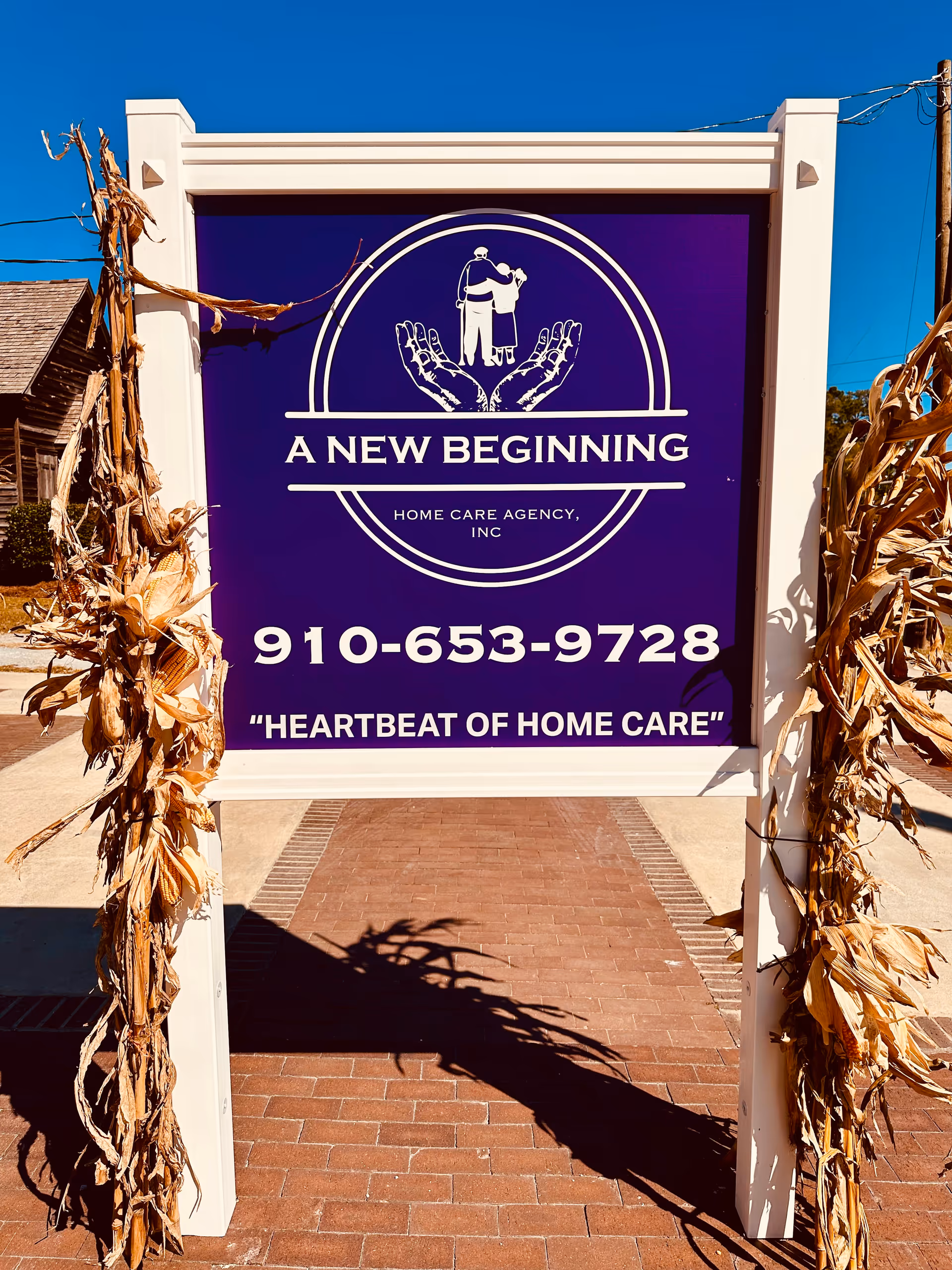 Purple sign reads A New Beginning Home Care Agency, Inc, with phone number.