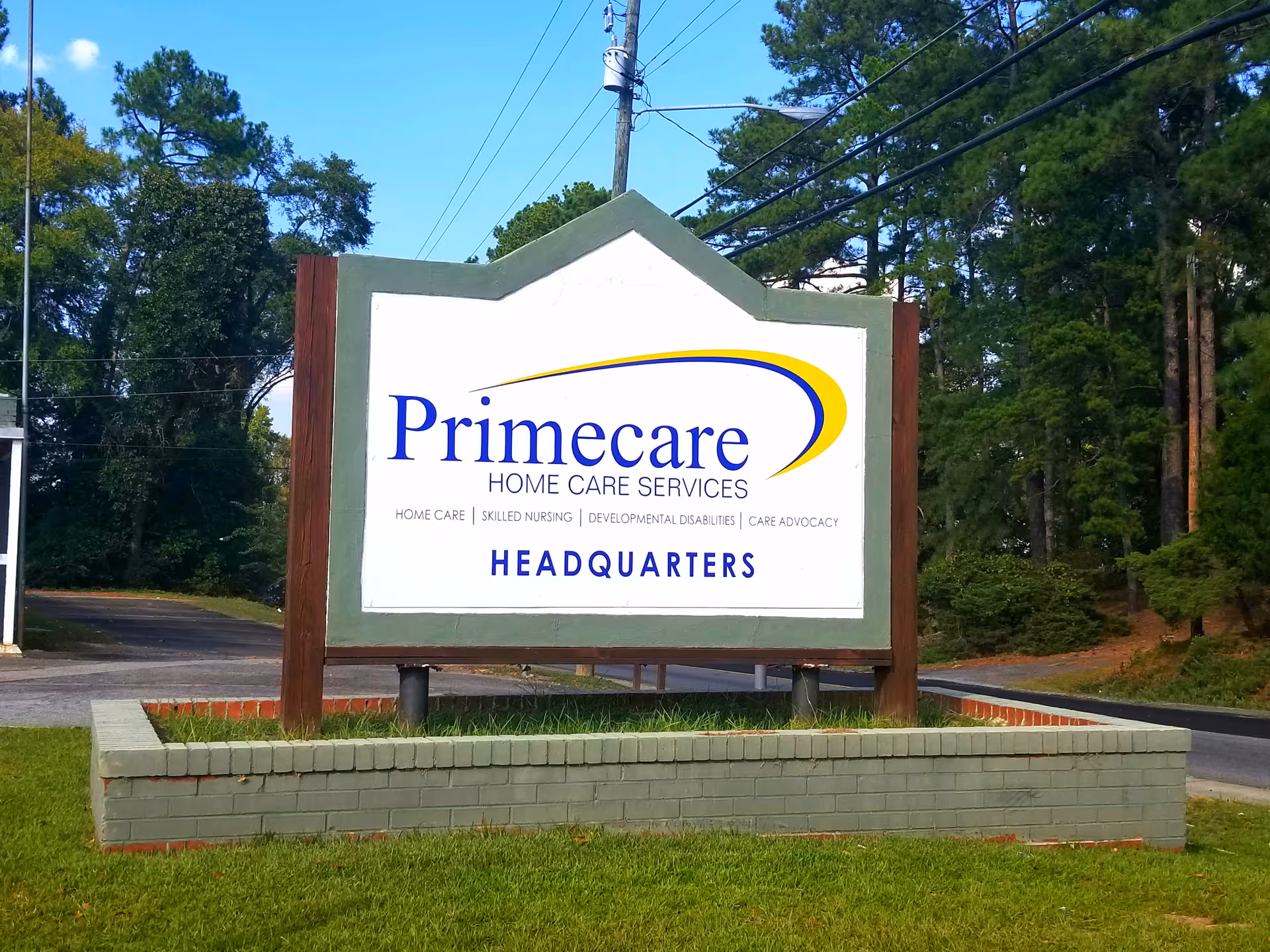 Primecare Home Care Services sign with Headquarters on a landscaped front yard