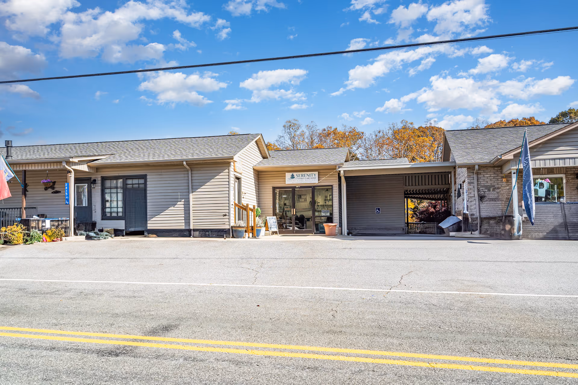 Row of single-story storefronts along a street, Serenity Family Care 2 sign visible.