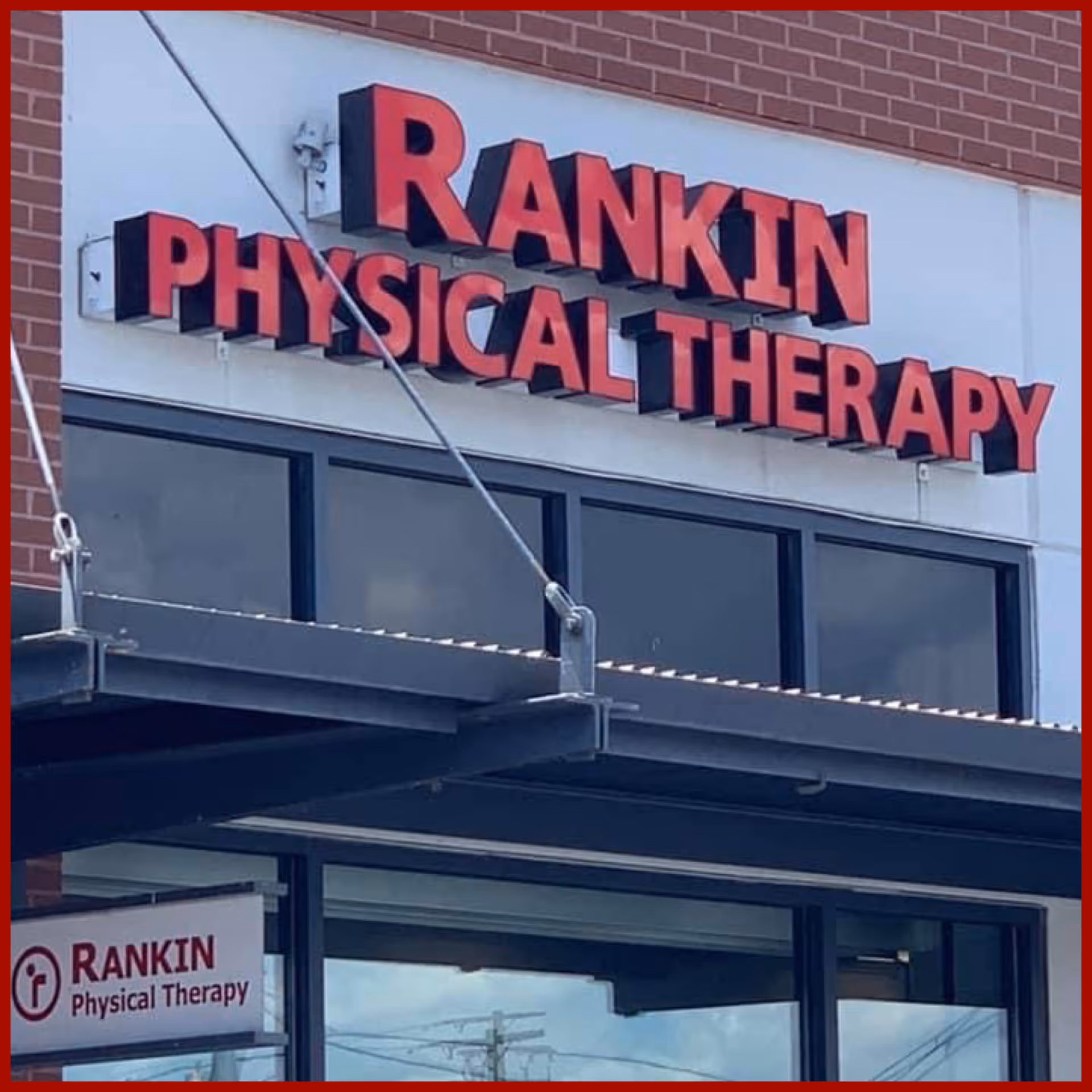Exterior view of Rankin Physical Therapy building with a large red sign.