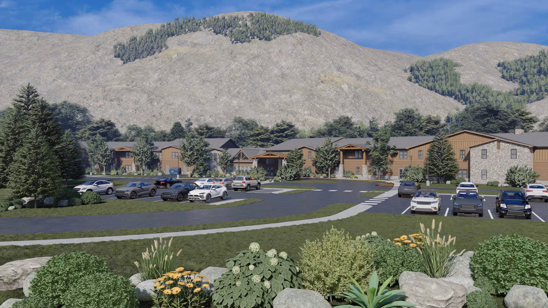Front exterior of Legacy Lodge at Jackson Hole, with parking and surrounding mountains.