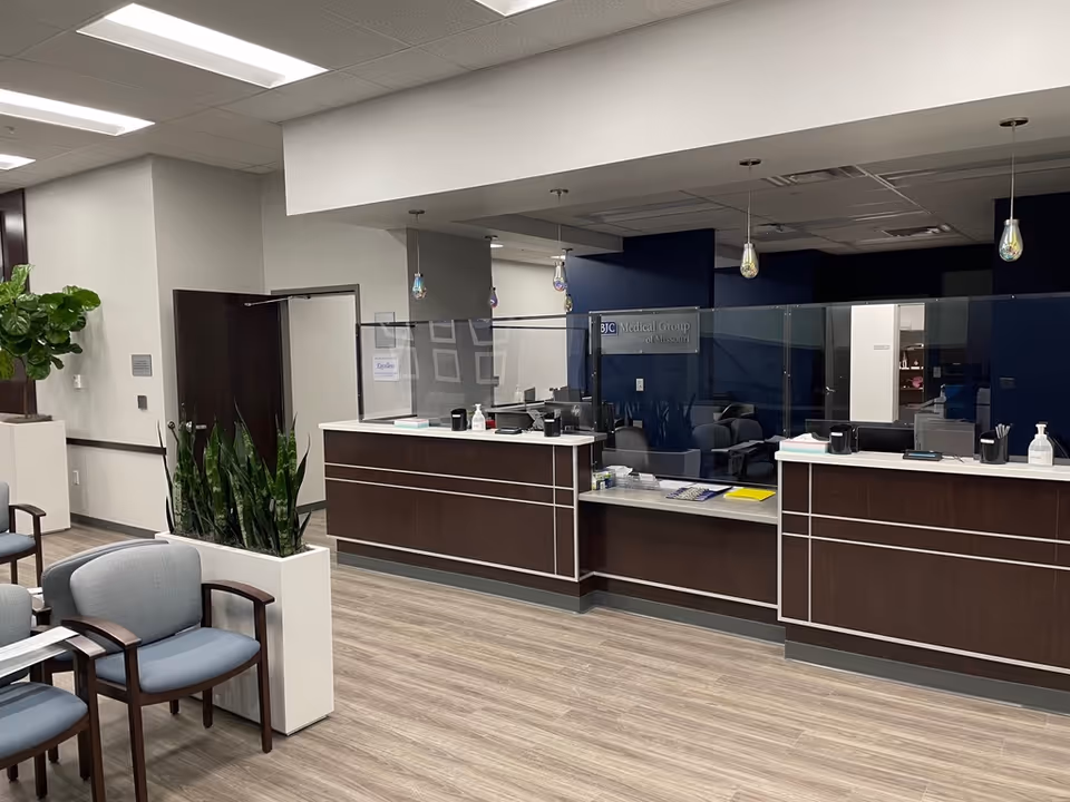 BJC Outpatient Center reception desk with glass partitions in a modern lobby.