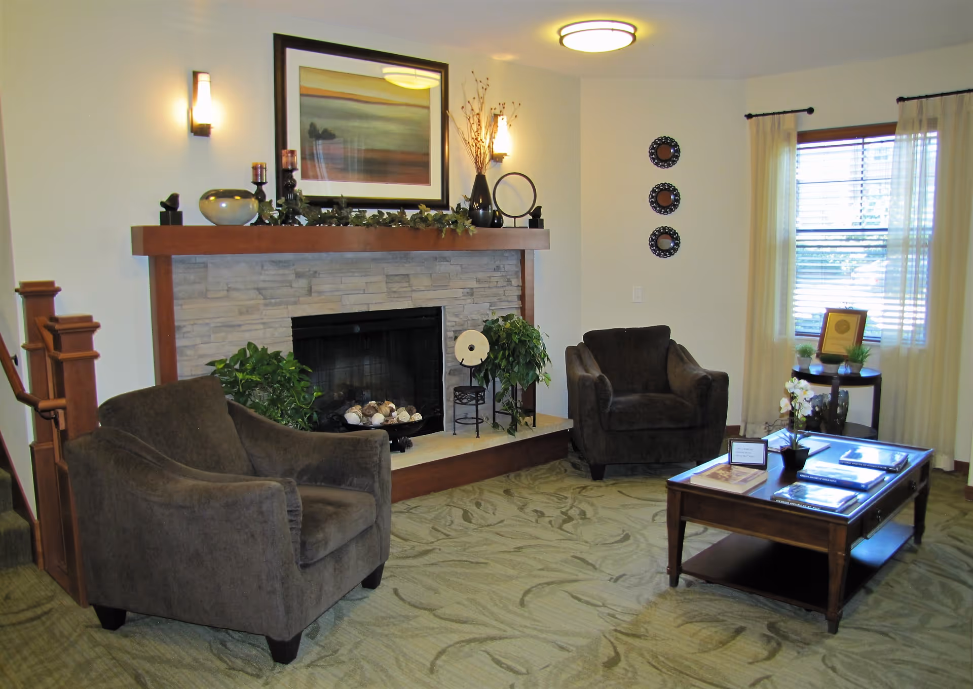 Cozy senior living room with a fireplace, two brown chairs, and a coffee table.