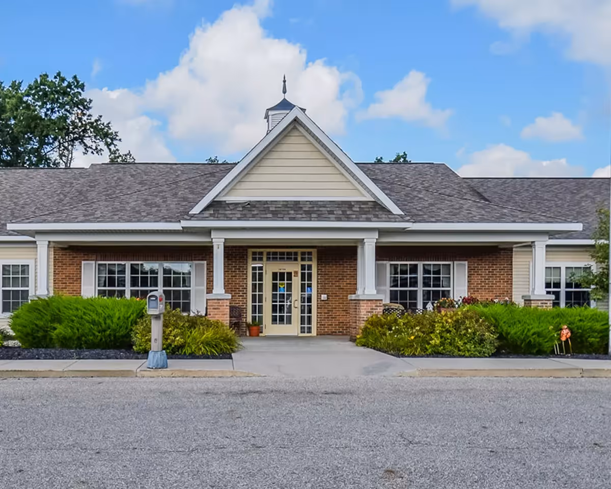 Front view of Forest Glen Assisted Living building with brick facade and landscaped entrance.