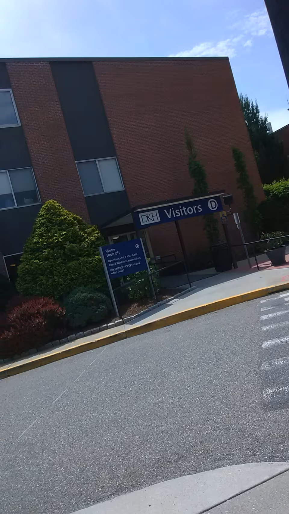 Exterior view of Day Kimball Healthcare with a visitor entrance sign.