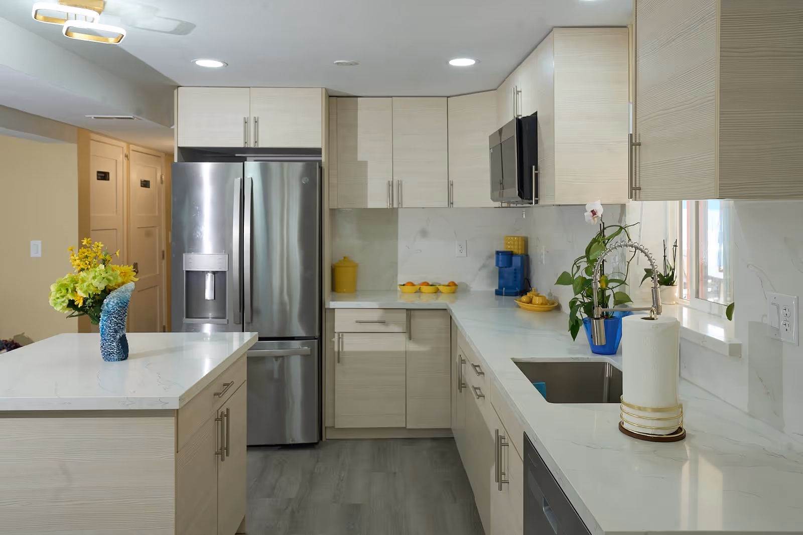 Bright modern kitchen in Apex Care Adult Family Home with white cabinets and island.