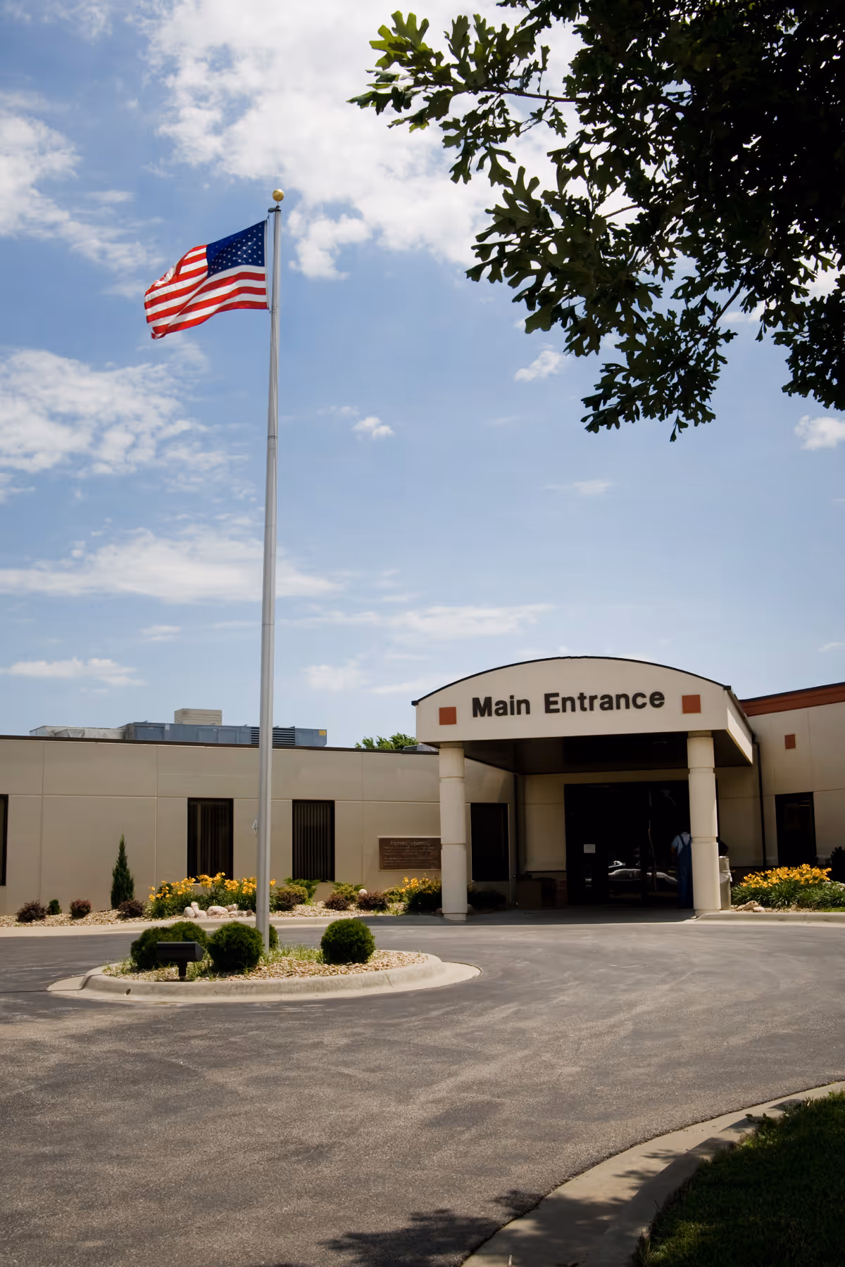 American flag on a flagpole in front of Coffey County Hospital main entrance.