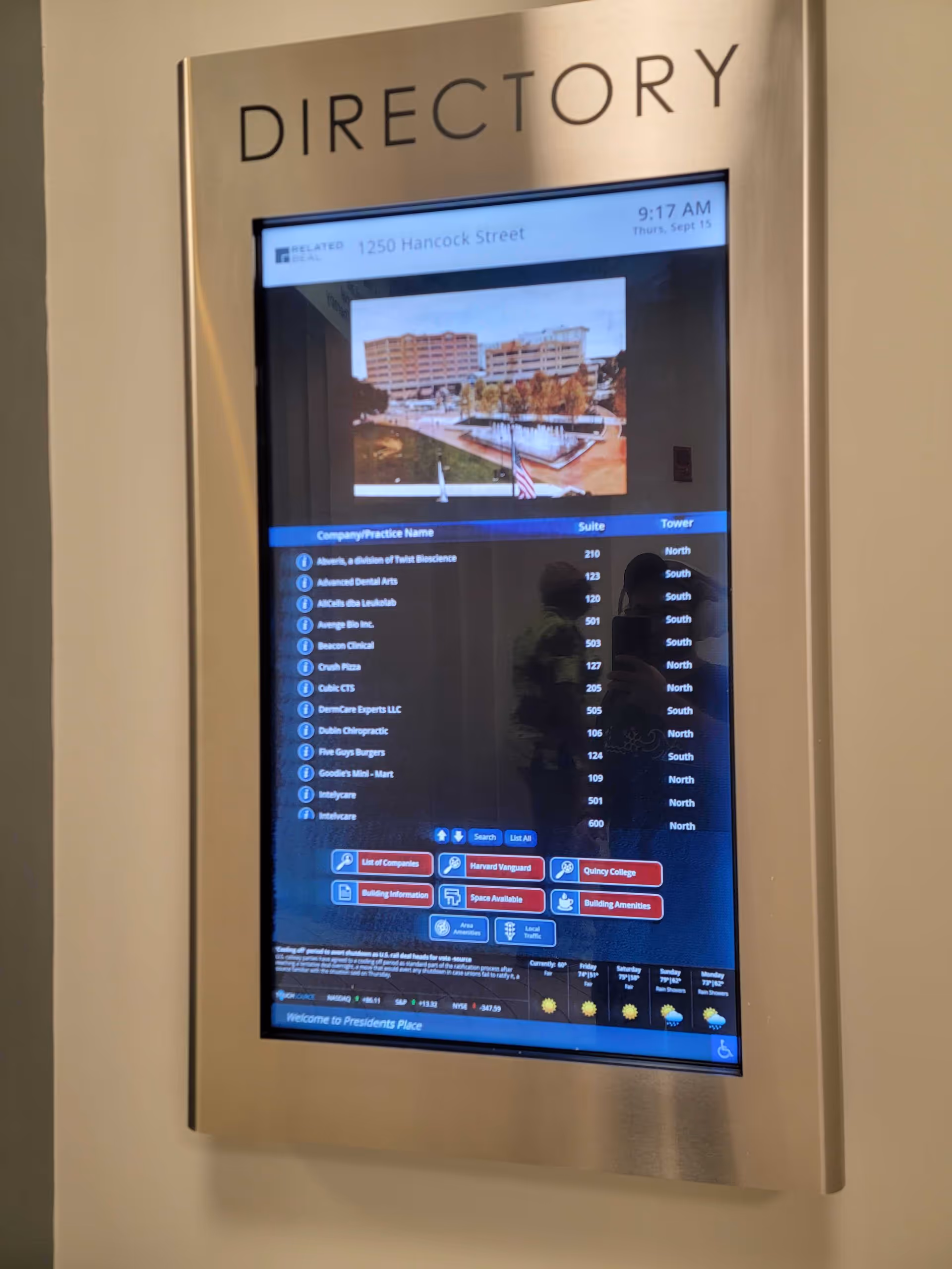 Wall-mounted digital directory screen inside a building labeled DIRECTORY at top.