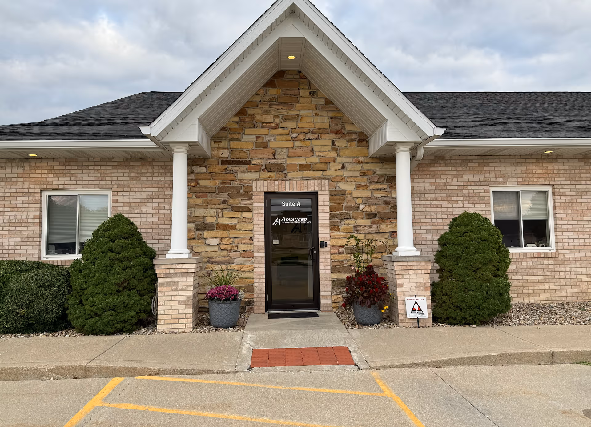 Entrance to Advanced Healthcare Services LLC building with brick and stone facade