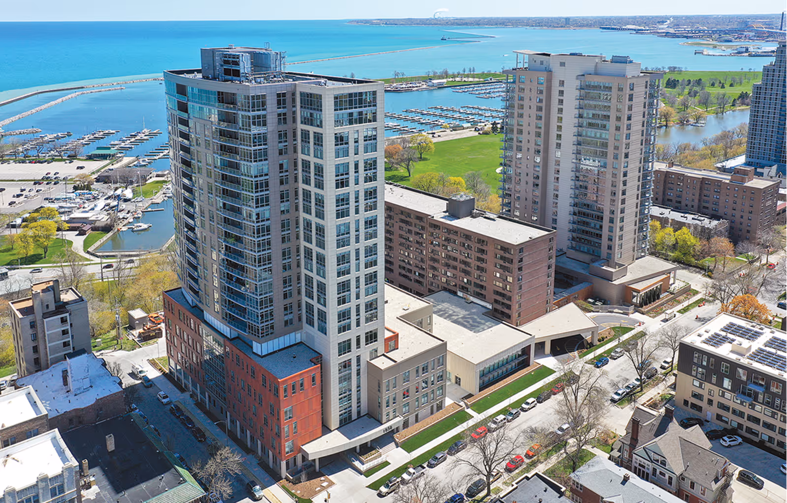 Aerial exterior view of waterfront campus with modern high-rise buildings