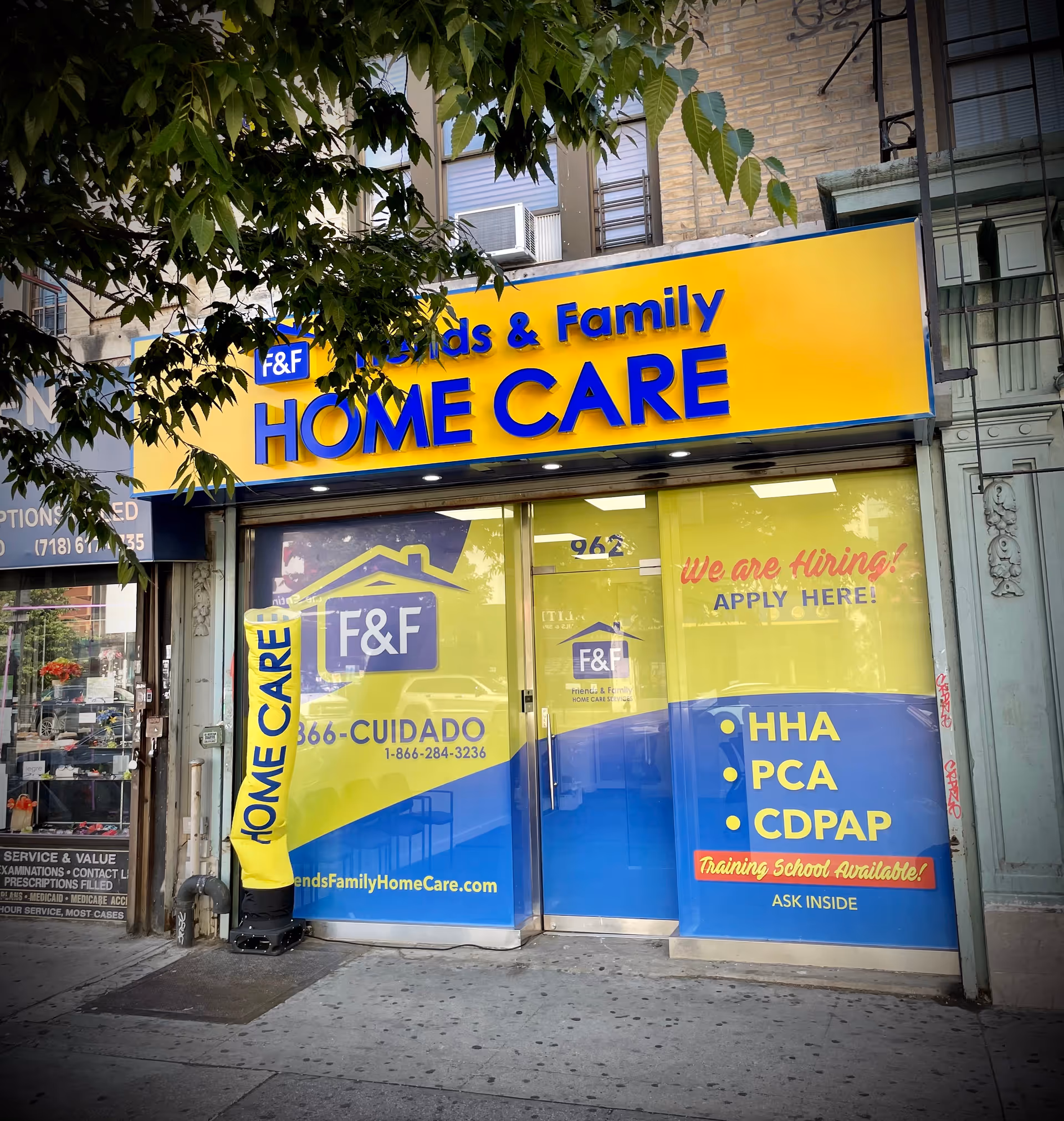 Bright yellow and blue storefront signage for Friends & Family Home Care on a city street.