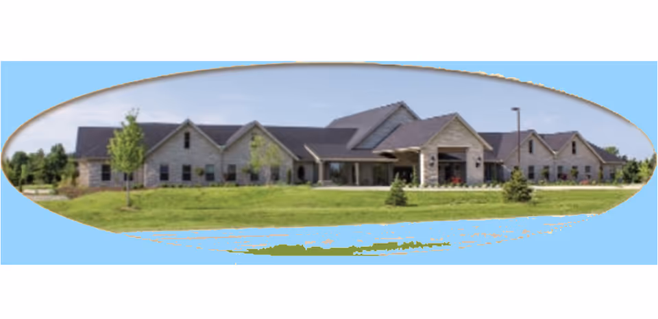 Exterior view of a single-story senior living facility with manicured lawn.