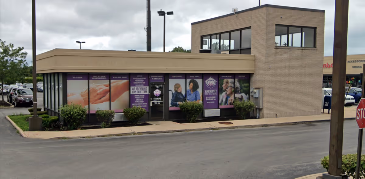 Front exterior of Serendipity Home Healthcare building with purple window banners.