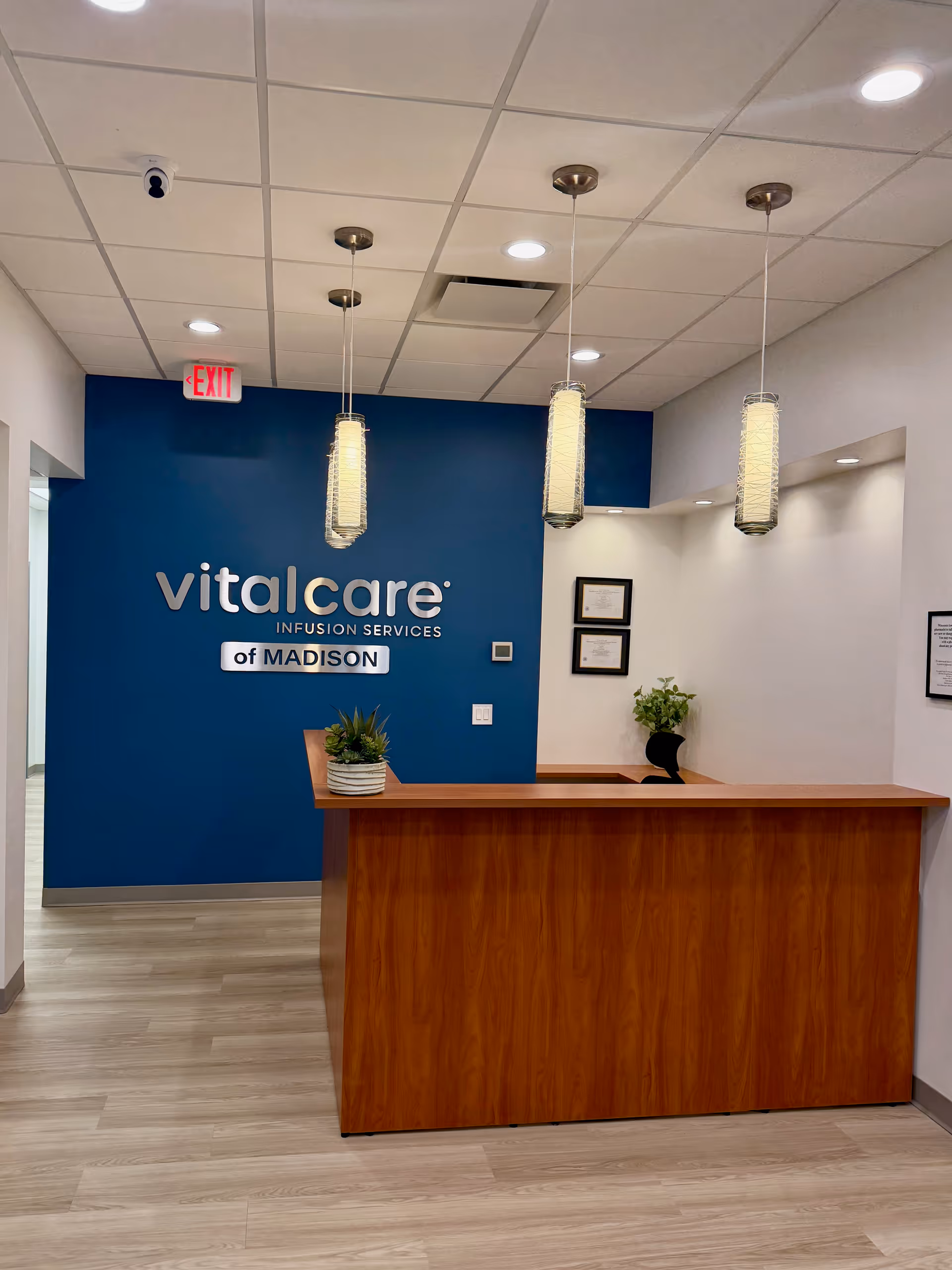 Reception desk in a blue-walled lobby with Vital Care Madison sign.