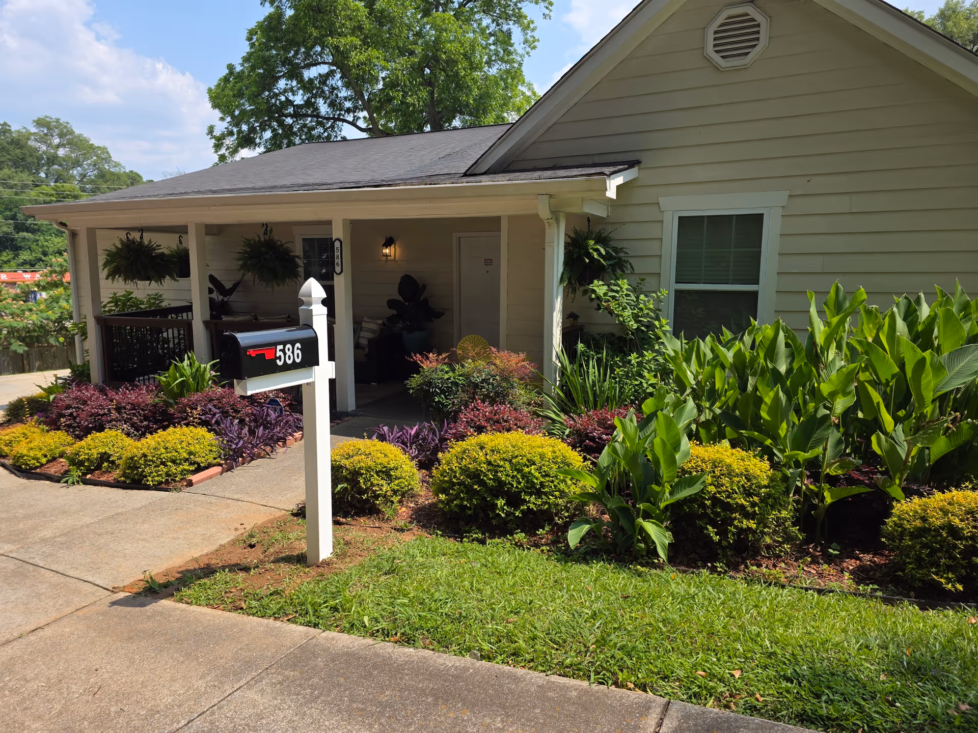 Front view of a single-story facility with landscaped yard and mailbox.
