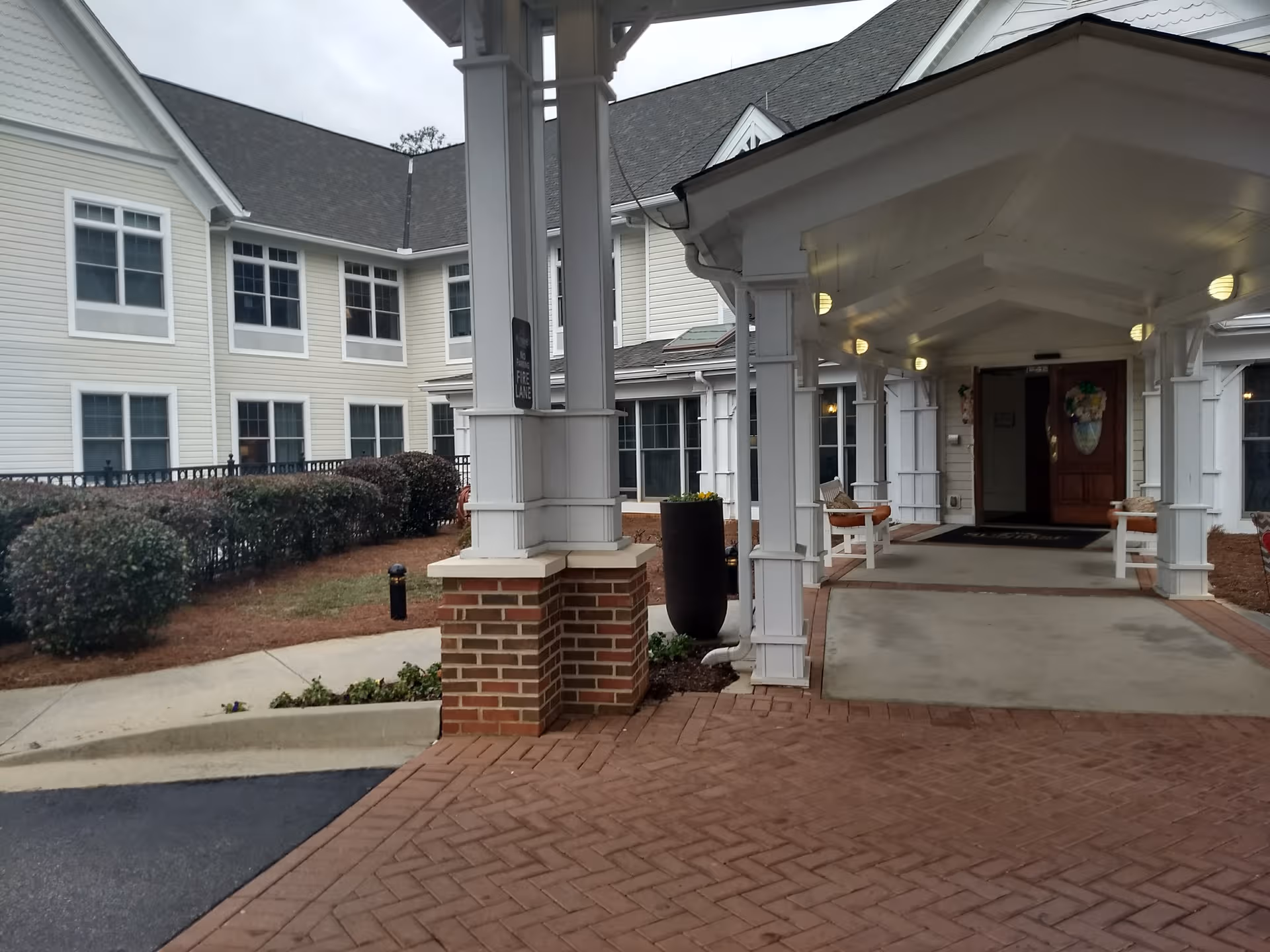 Entrance to Assisted Living-Five Forks, with white columns and brick walkway.