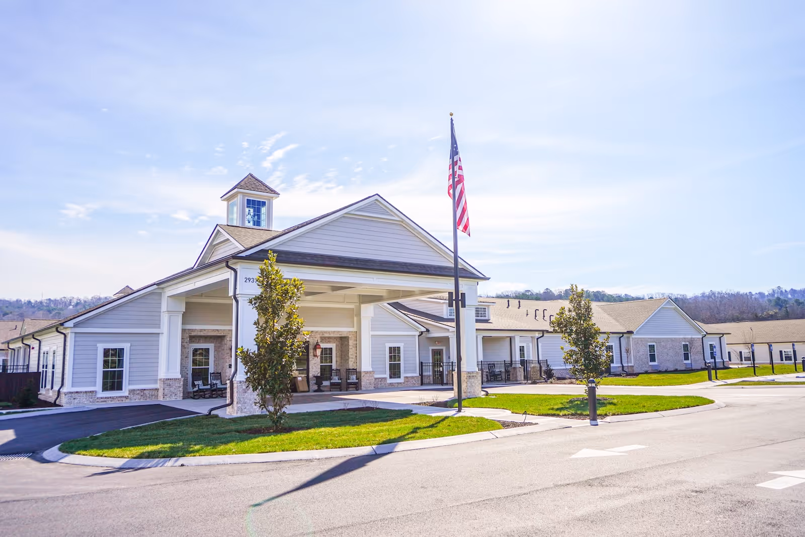 Exterior view of The Lantern at Morning Pointe Happy Valley with flag and entrance.