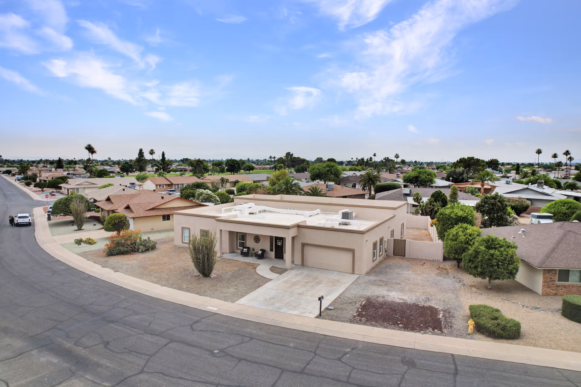 Aerial view of a single-story senior living building in a desert suburban neighborhood.