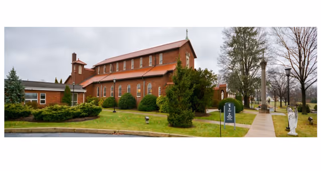 Brick facility building with manicured lawn, trees, and a walkway outside Salams Care Residential.