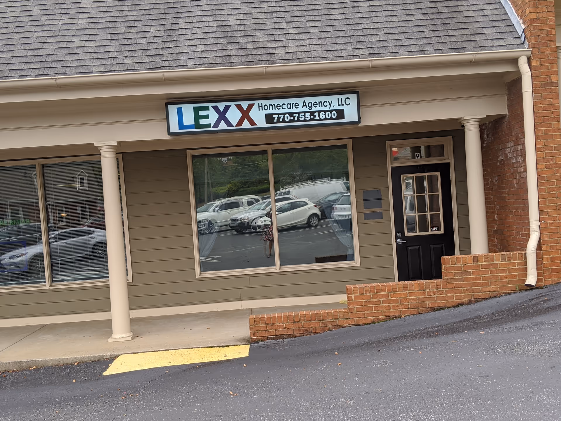 Storefront of LEXX Homecare Agency, LLC with large window, door, and sign.
