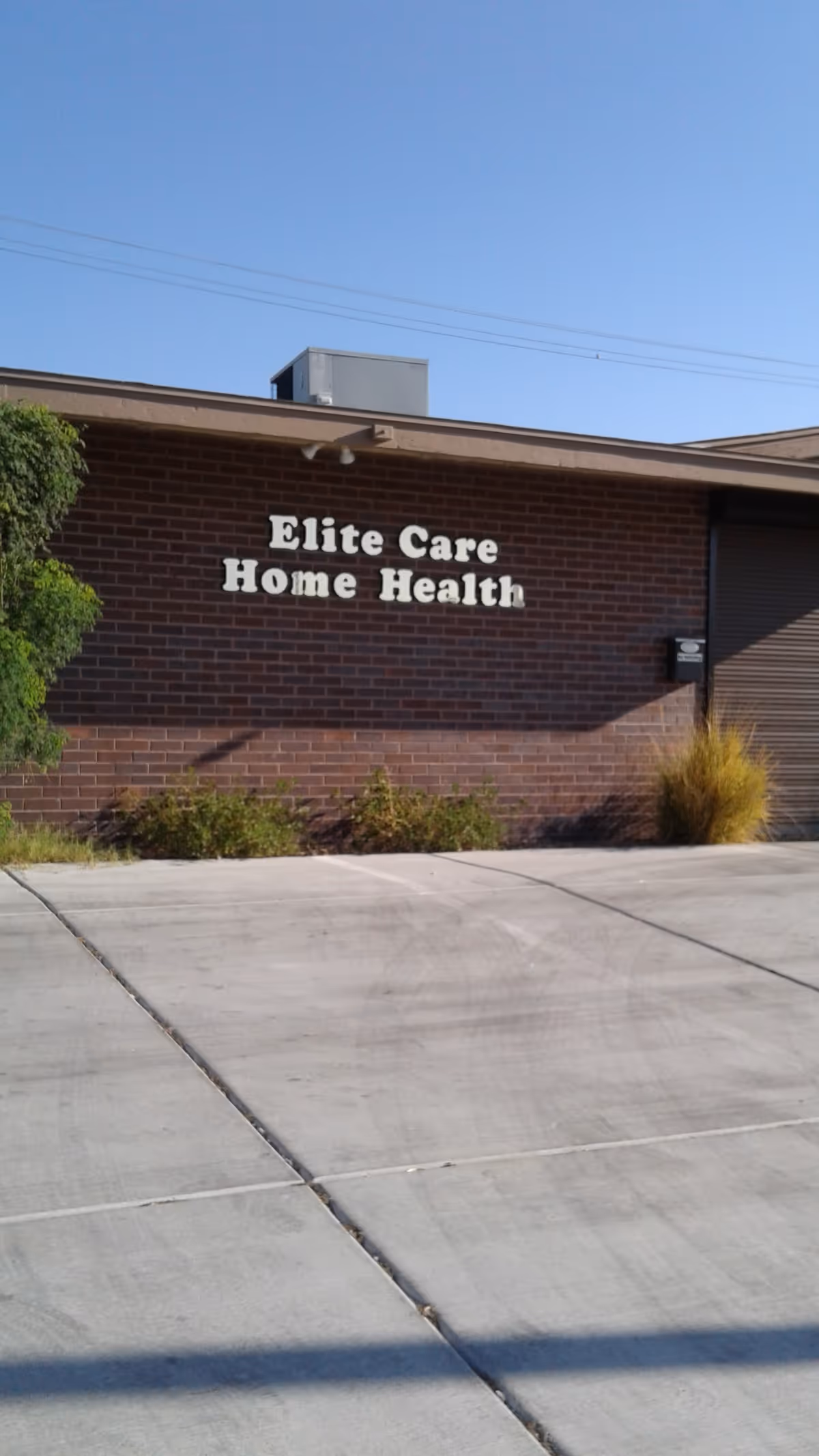 Exterior brick building with 'Elite Care Home Health' sign on wall