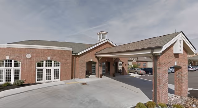 Exterior view of St. Charles Community senior living facility with brick building and covered entry.