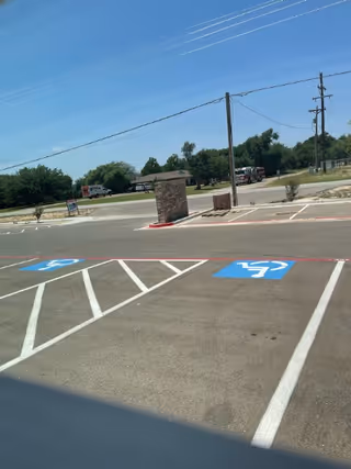 Parking lot of a senior care facility with blue handicap parking spaces.