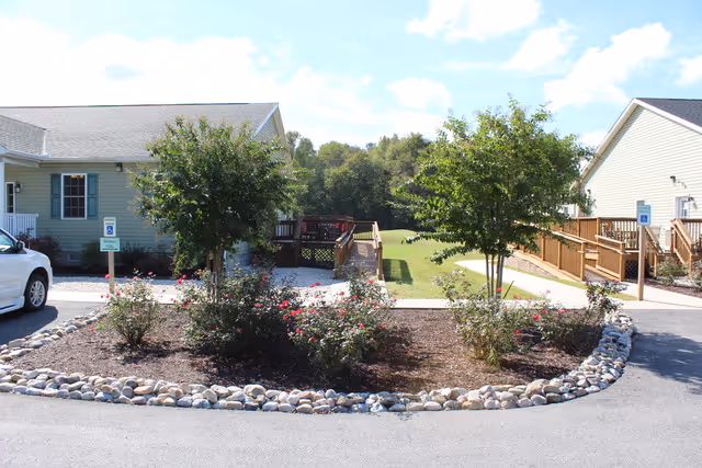 Front view of Delmar Villa Assisted Living with landscaped island and walkway.