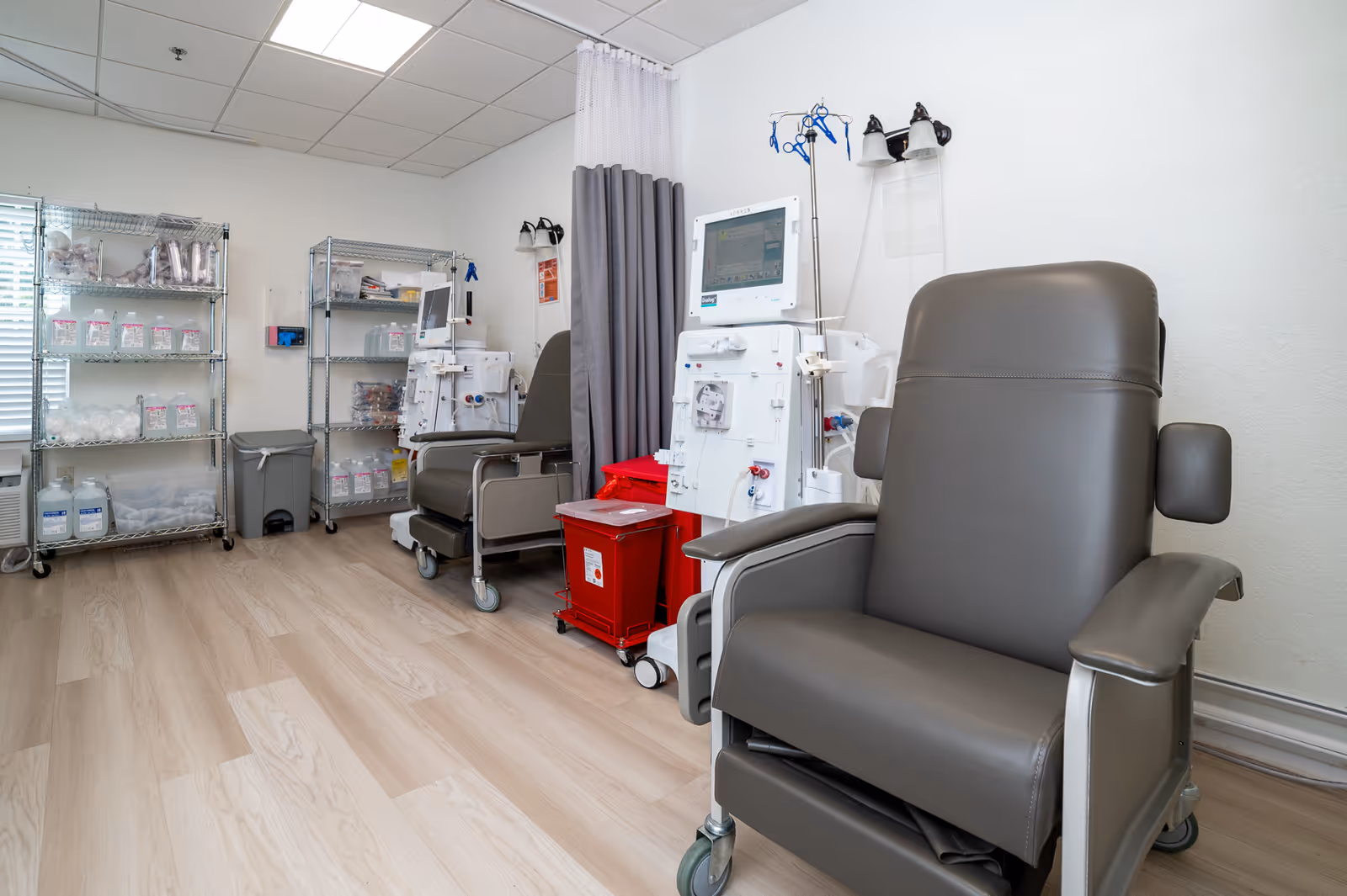 Coral Reef Subacute Care Center treatment room with dialysis chairs, IV poles, and supplies.