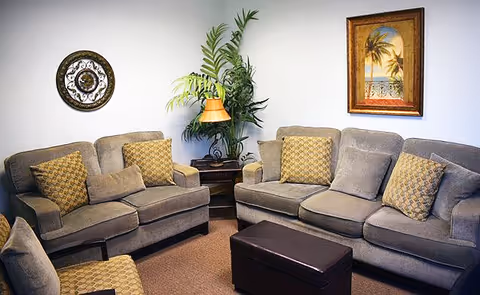Two gray sofas with patterned pillows face each other in a cozy living room.