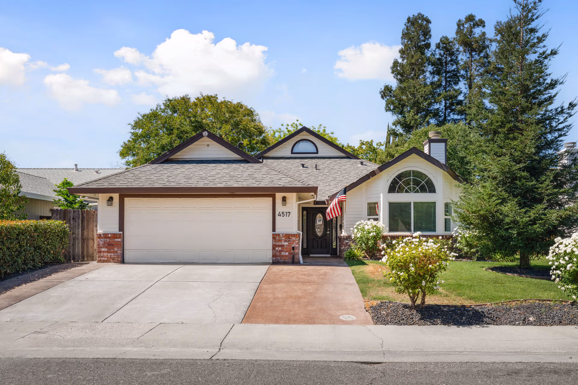 Front view of a suburban house with a two-car garage and manicured lawn.