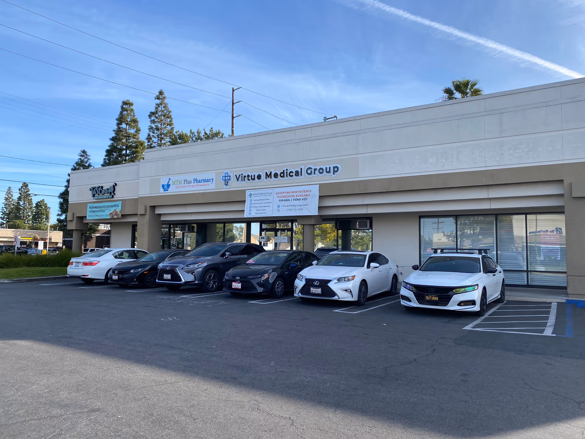 Exterior view of Virtue Medical Group building with several parked cars in front.