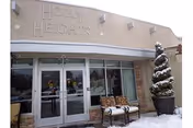 Front exterior of Holly Heights Nursing Care Center with glass doors and snow