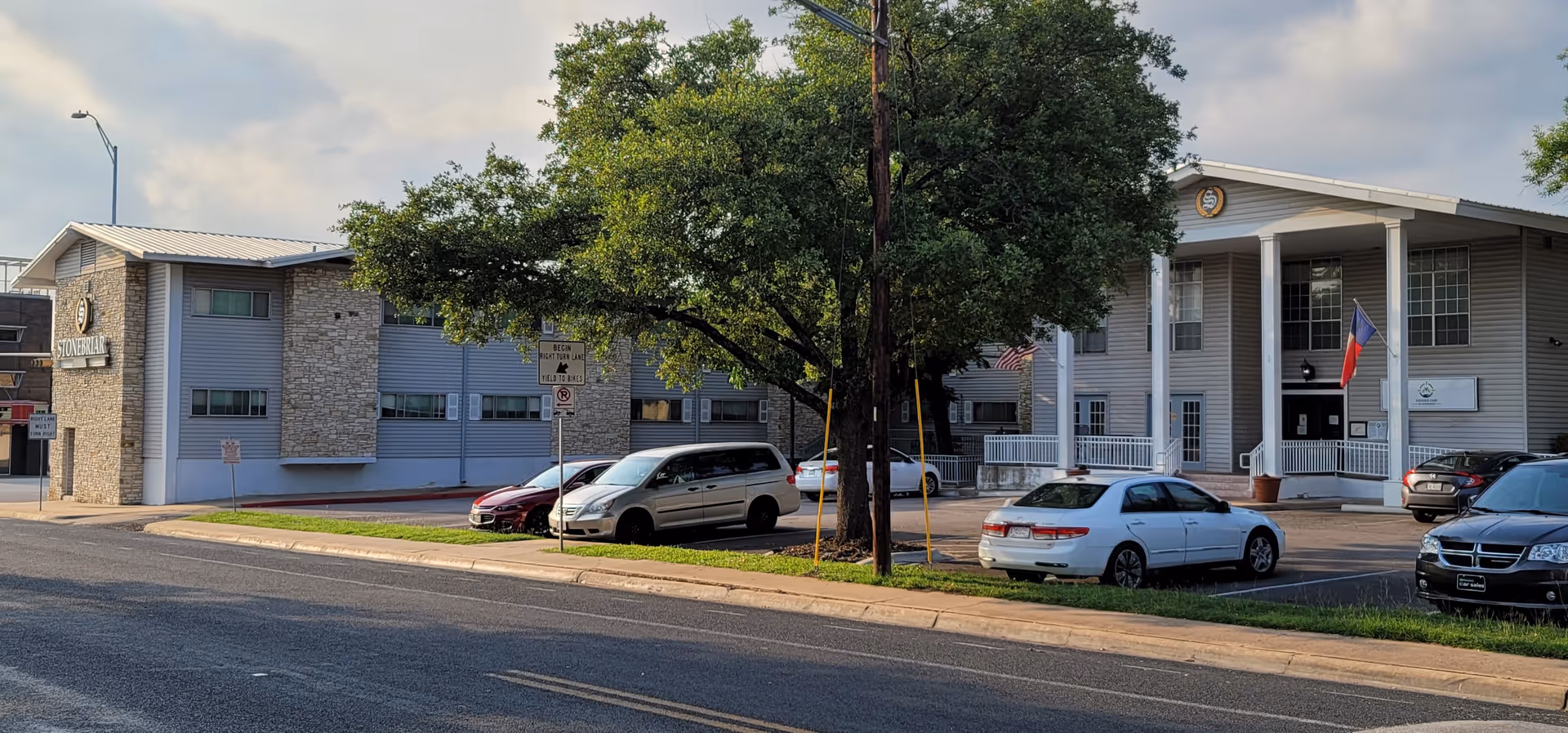 Exterior view of Focused Care at Stonebriar facility with parked cars along the curb.